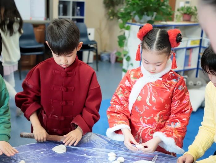 Elementary students making dumplings