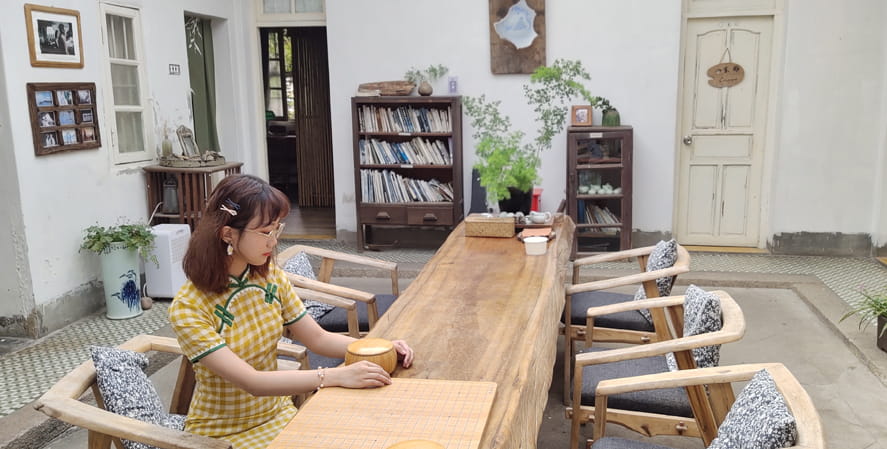 Girl sitting by the table